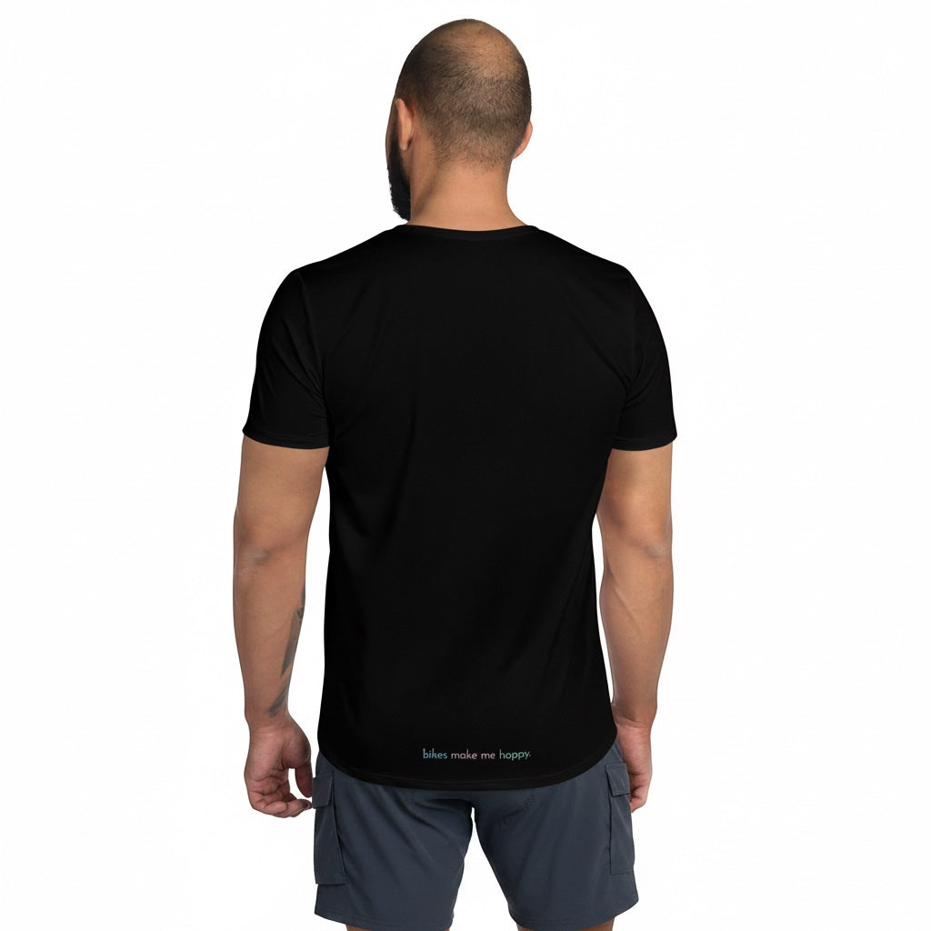 Back view of a man wearing a Bikes Make Me Happy black performance riding shirt with small logo at the hem