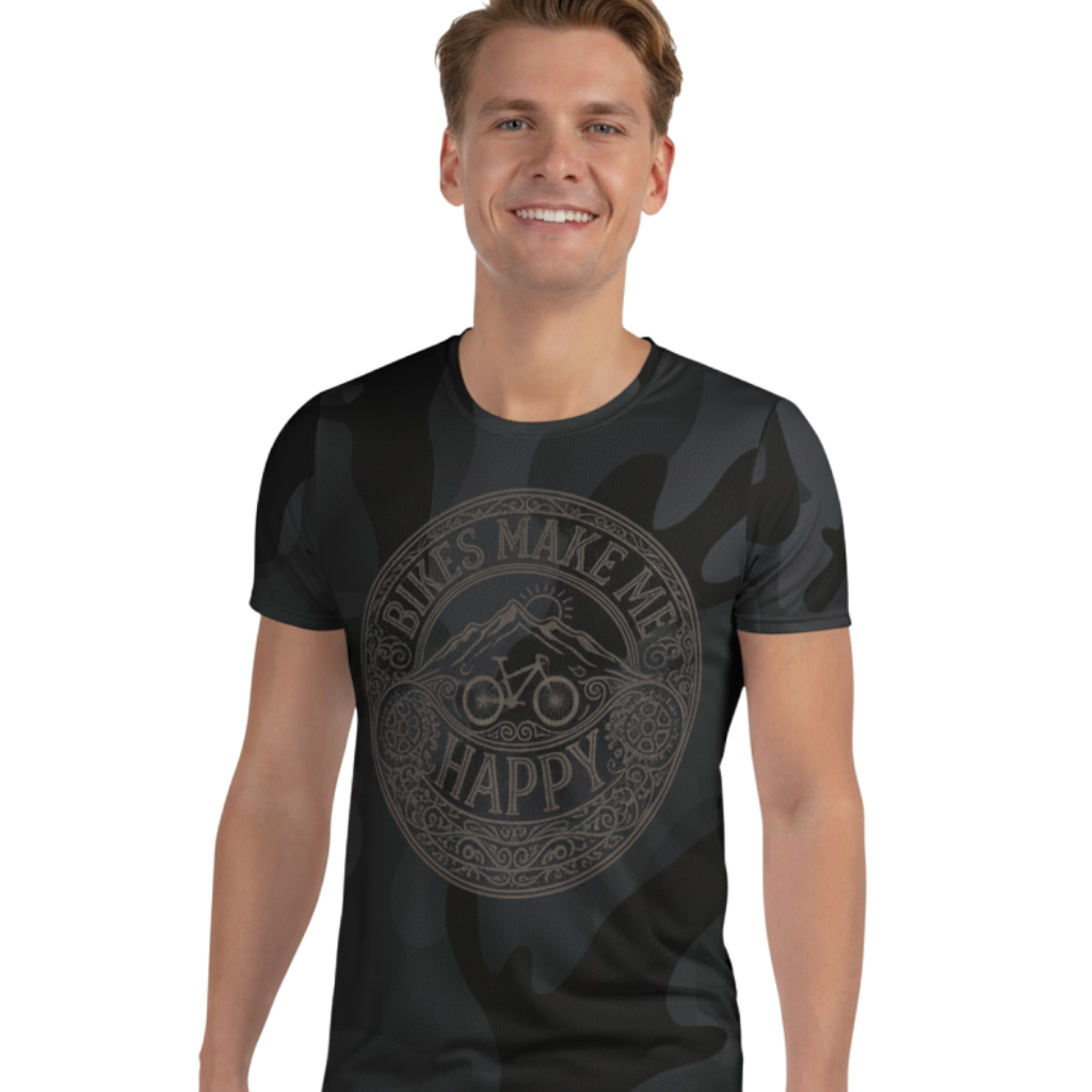 A man wearing a Bikes Make Me Happy black and gray camo performance riding shirt with an etched graphic design.
