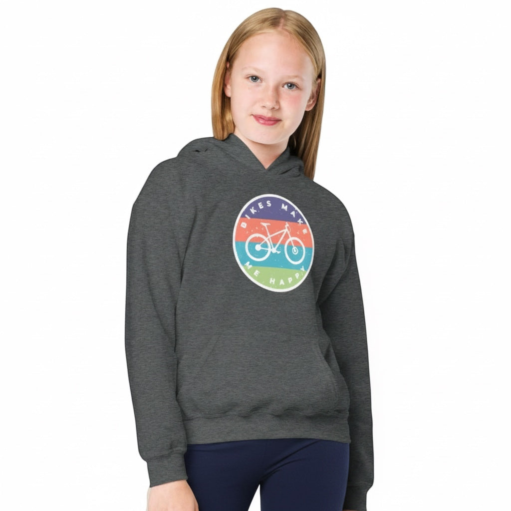 Young girl wearing a charcoal grey Bikes Make Me Happy youth hoodie with a colourful circular bicycle badge graphic.