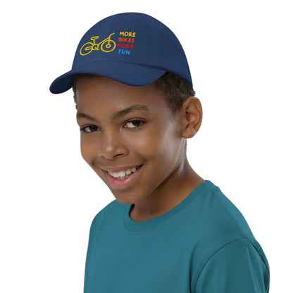 Bikes Make Me Happy youth navy baseball cap with yellow bicycle graphic and More Bikes More Fun text on a young boy