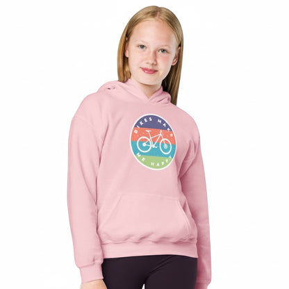 Young girl wearing a light pink Bikes Make Me Happy youth hoodie with a circular graphic badge on the chest.