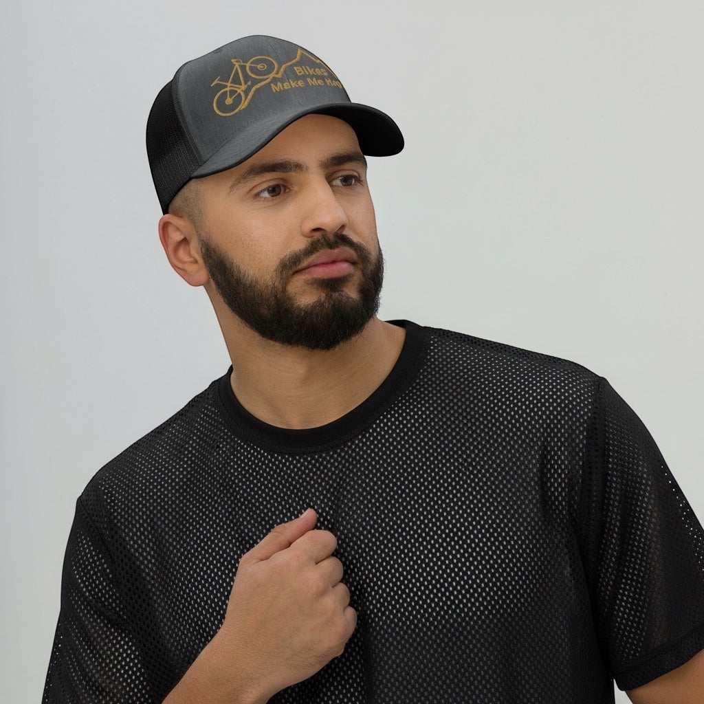 Bikes Make Me Happy mid-profile trucker hat with mountain and bike graphic worn by a man in a black mesh shirt