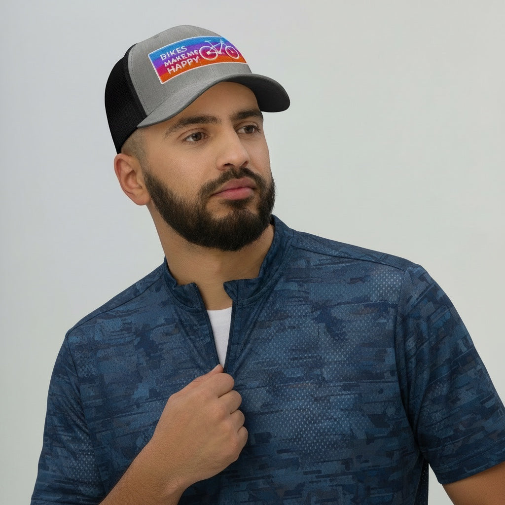 Bikes Make Me Happy trucker hat with grey front, black mesh back, and colorful embroidered cycling badge on a man.
