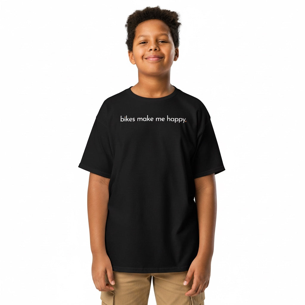 A young boy wearing a black Bikes Make Me Happy cotton t-shirt with the text bikes make me happy printed on the chest.