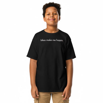 A young boy wearing a black Bikes Make Me Happy cotton t-shirt with the text bikes make me happy printed on the chest.